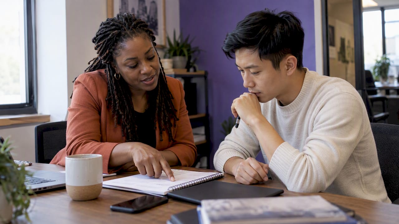 Broker and new agent reviewing a coaching plan