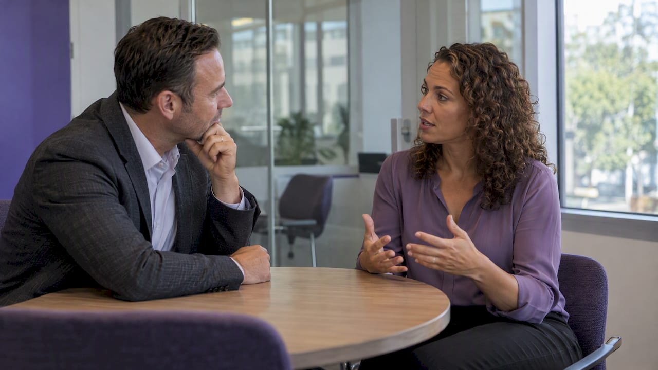 Real estate manager coaching an agent one-on-one